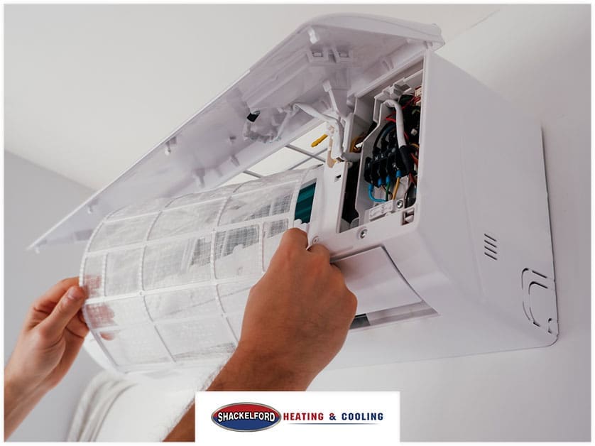 Looking at an HVAC unit to make sure it is clean