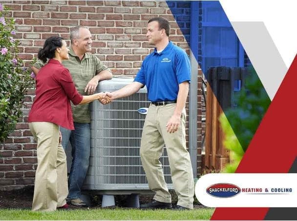 A couple thanking a technician for helping with their HVAC problems