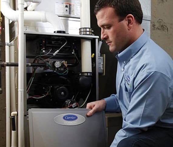 HVAC technician opening a furnace for inspection
