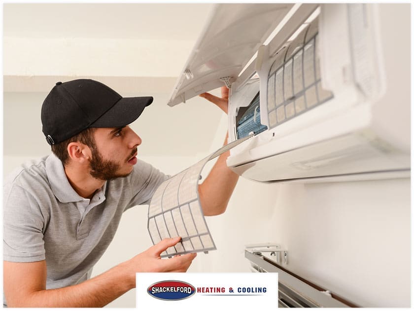 A technician working on an HVAC system