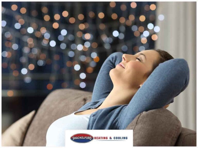 A women stretching back on her sofa enjoying the clean air