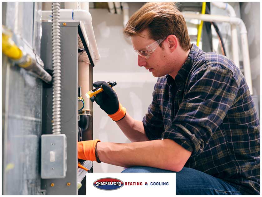 A technician working on an HVAC system