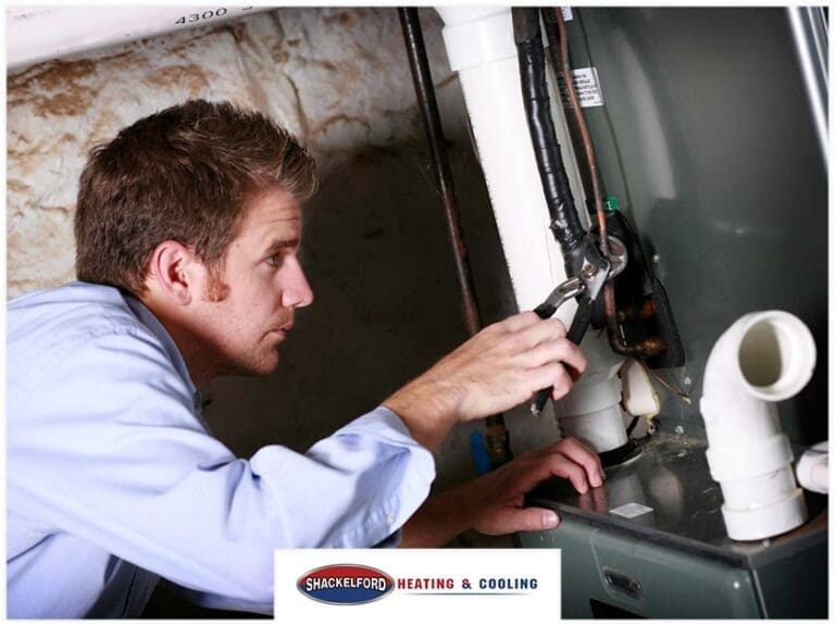 A man installing a new furnace
