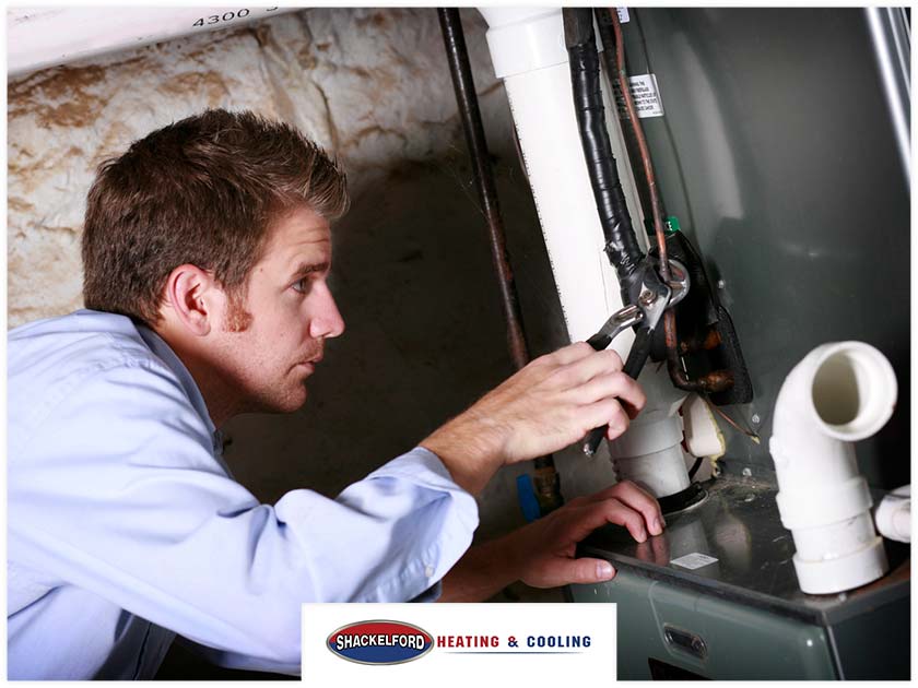 A man installing a new furnace
