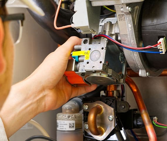 HVAC technician doing service maintenance on a furnace