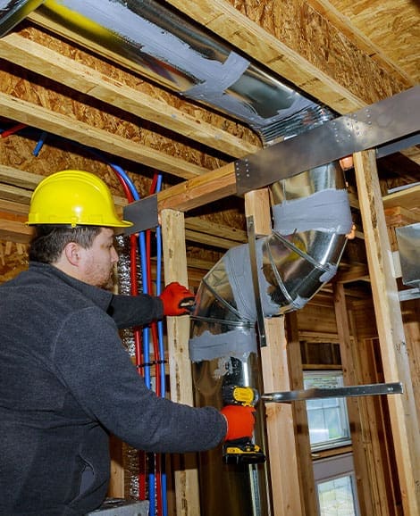 HVAC technician servicing ductwork
