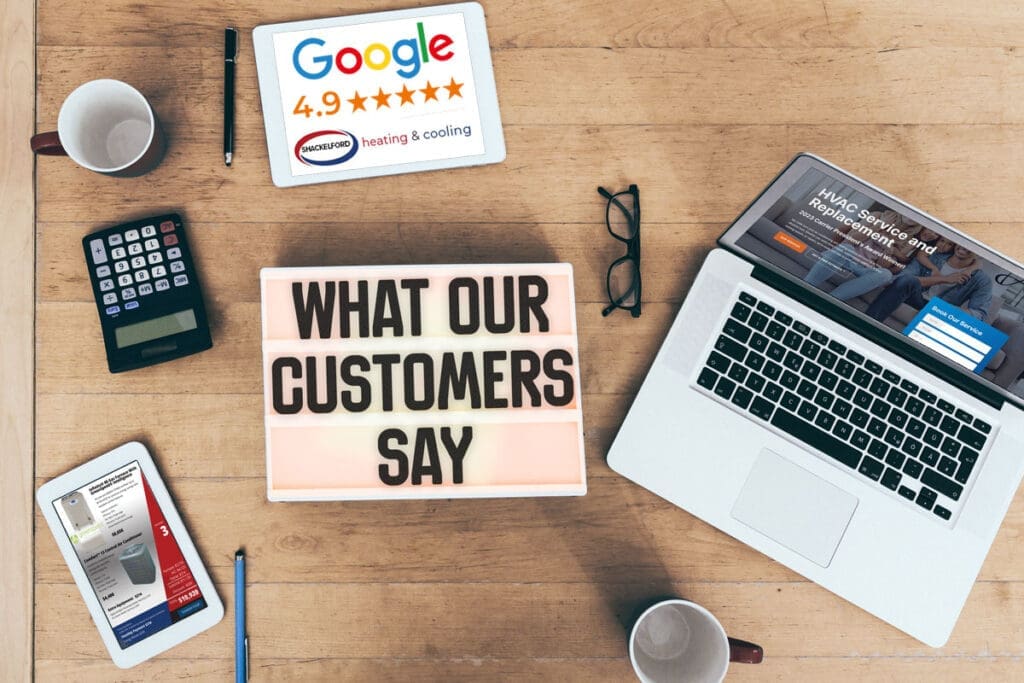 Desk with phone, laptop, tablet and calculator with a sign saying What Our Customers Say