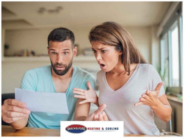 A man and women looking at a bill in utter disbelief