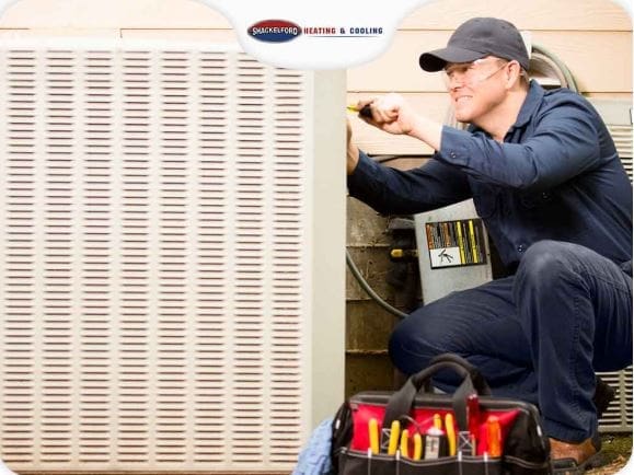 A man fixing an HVAC system.