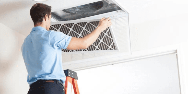 A man cleaning an air duct