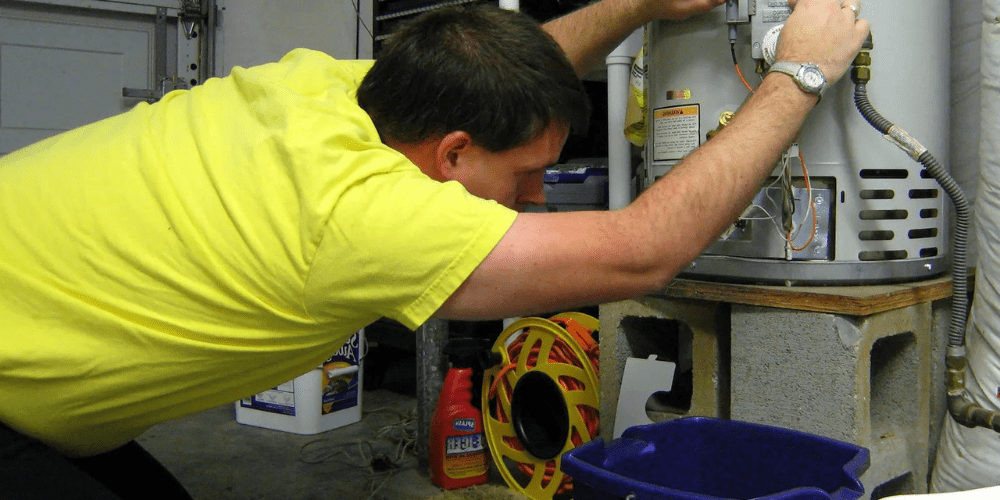 A man working on a water heater