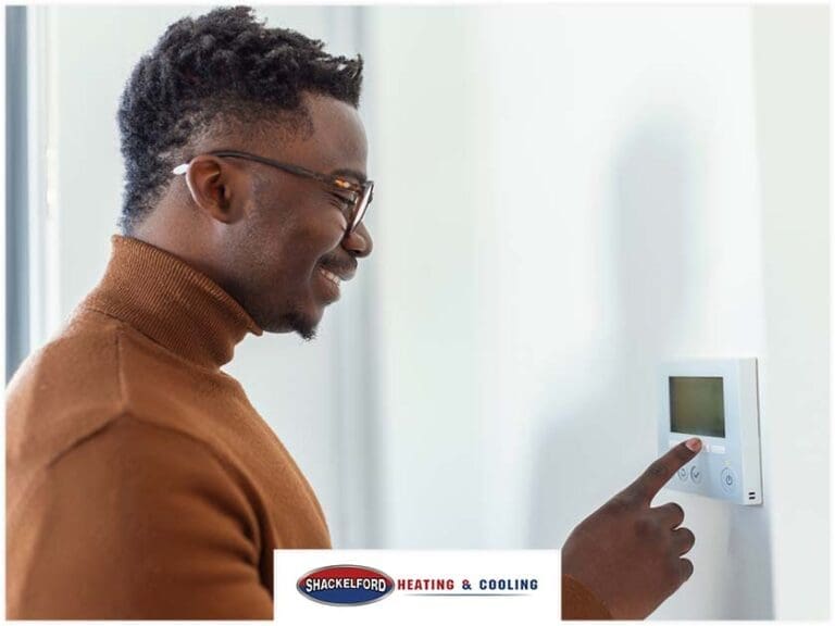 A man happy looking at his new thermostat