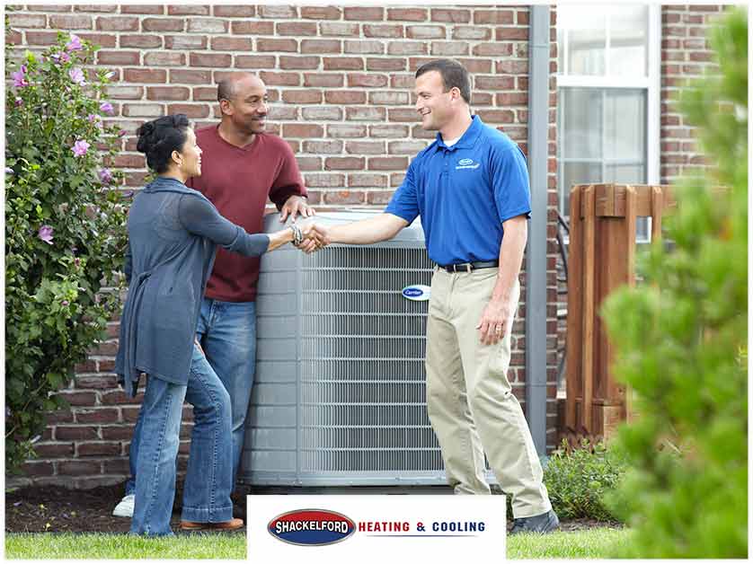 A family thanking a technician for installing a new unit