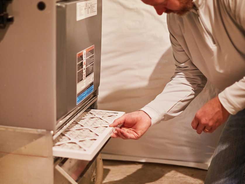 A man installing a new air filter