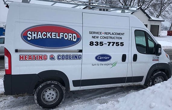 Shackelford branded service van parked in the snow at customer's house