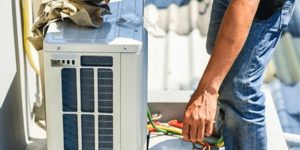 A man installing a new A/C unit