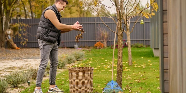 Man raking yard for fall cleanup