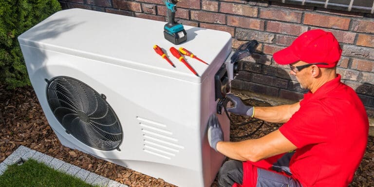 Service technician installing a new heat pump